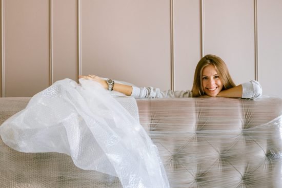 woman-smiling-behind-the-headboard-3616688